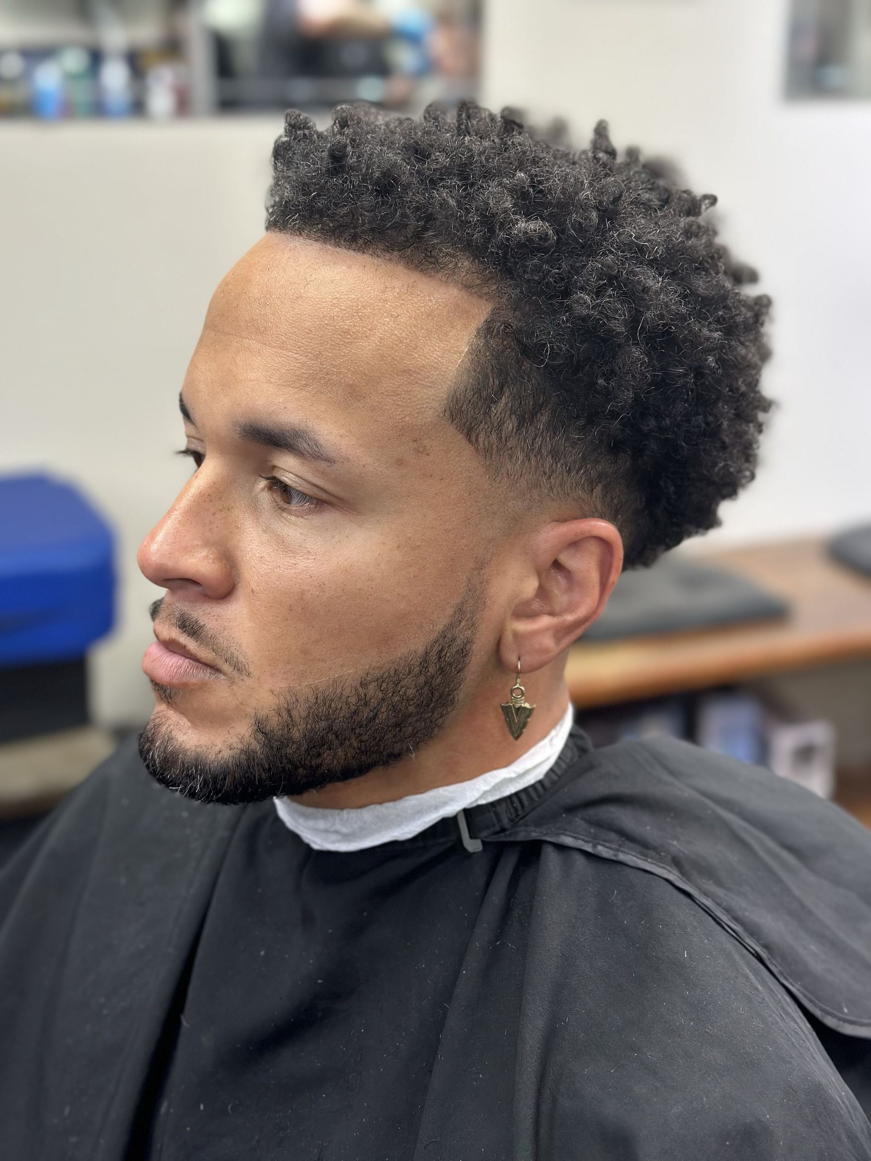 Close-up of a textured cut with a taper and shaped beard